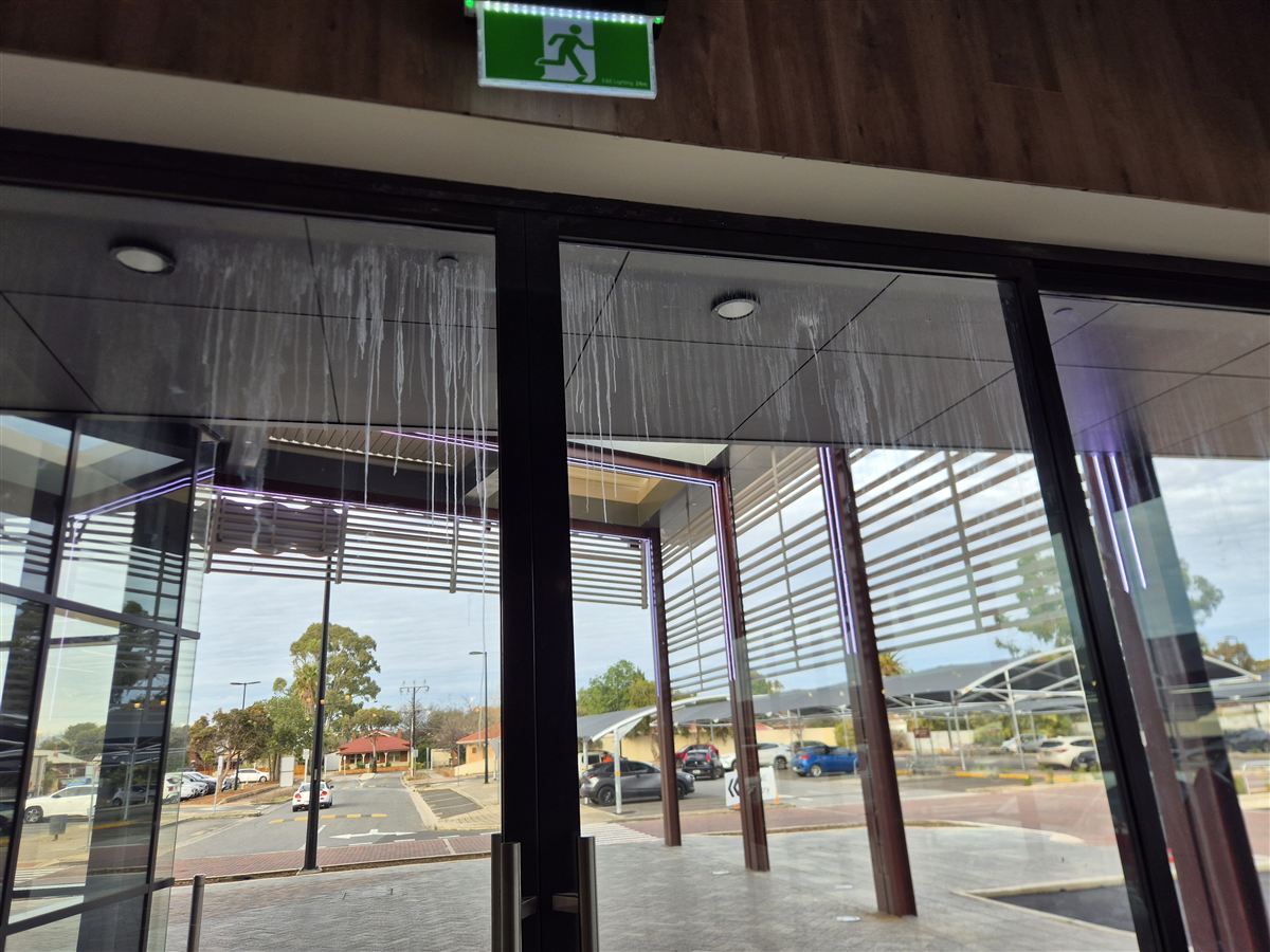 Dust and marks on entrance glass before cleaning