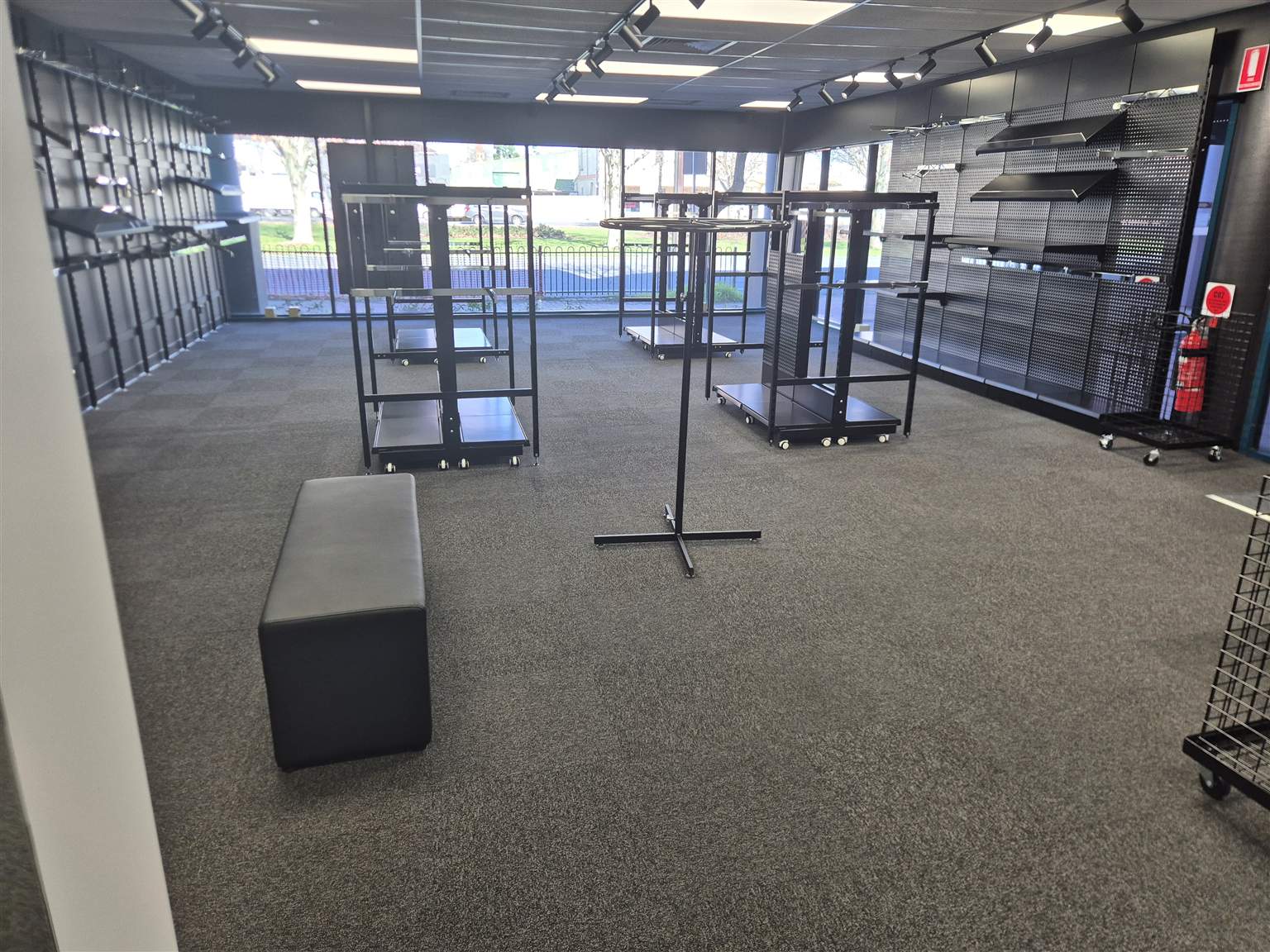 Original MisterClean project photo looking across a carpeted Hindmarsh retail floor towards the glass shopfront